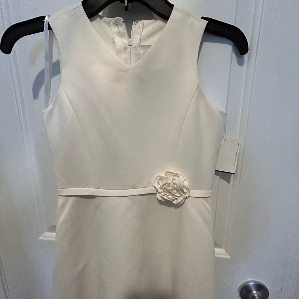 Elegant White Sleeveless Dress with Floral Accent